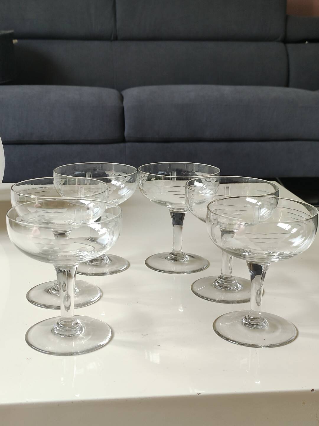 Set of 6 Baccarat-style champagne glasses. Stylized grape cluster decoration.