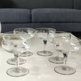 Set of 6 Baccarat-style champagne glasses. Stylized grape cluster decoration.