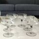 Set of 6 Baccarat-style champagne glasses. Stylized grape cluster decoration.