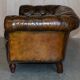 Victorian Chesterfield leather upholstered canapé with feather cushions.