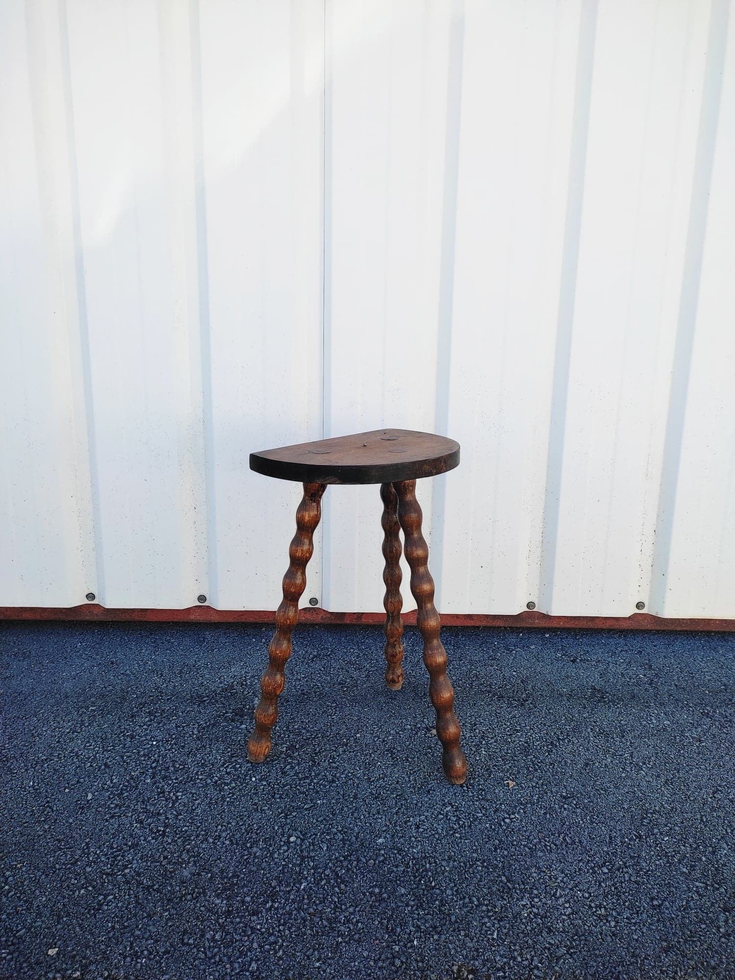 Pretty wooden stool with half moon seat and turned wooden tripod base
