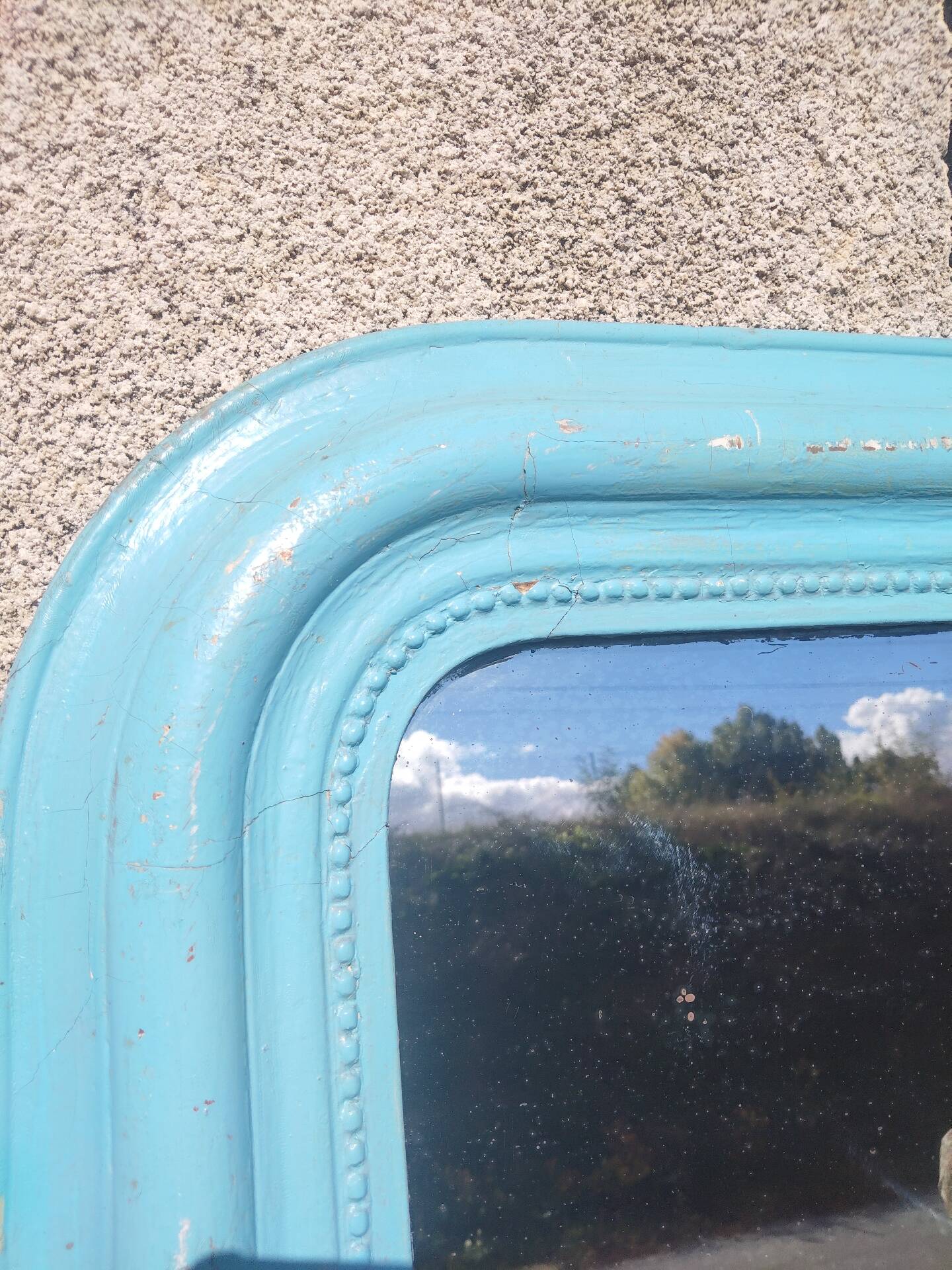 Large Louis-Philippe mirror from the 19th century in wood and stucco with a turquoise blue patina.