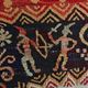 Vintage handwoven tapestry with a folk scene and archaic Slavic writing.