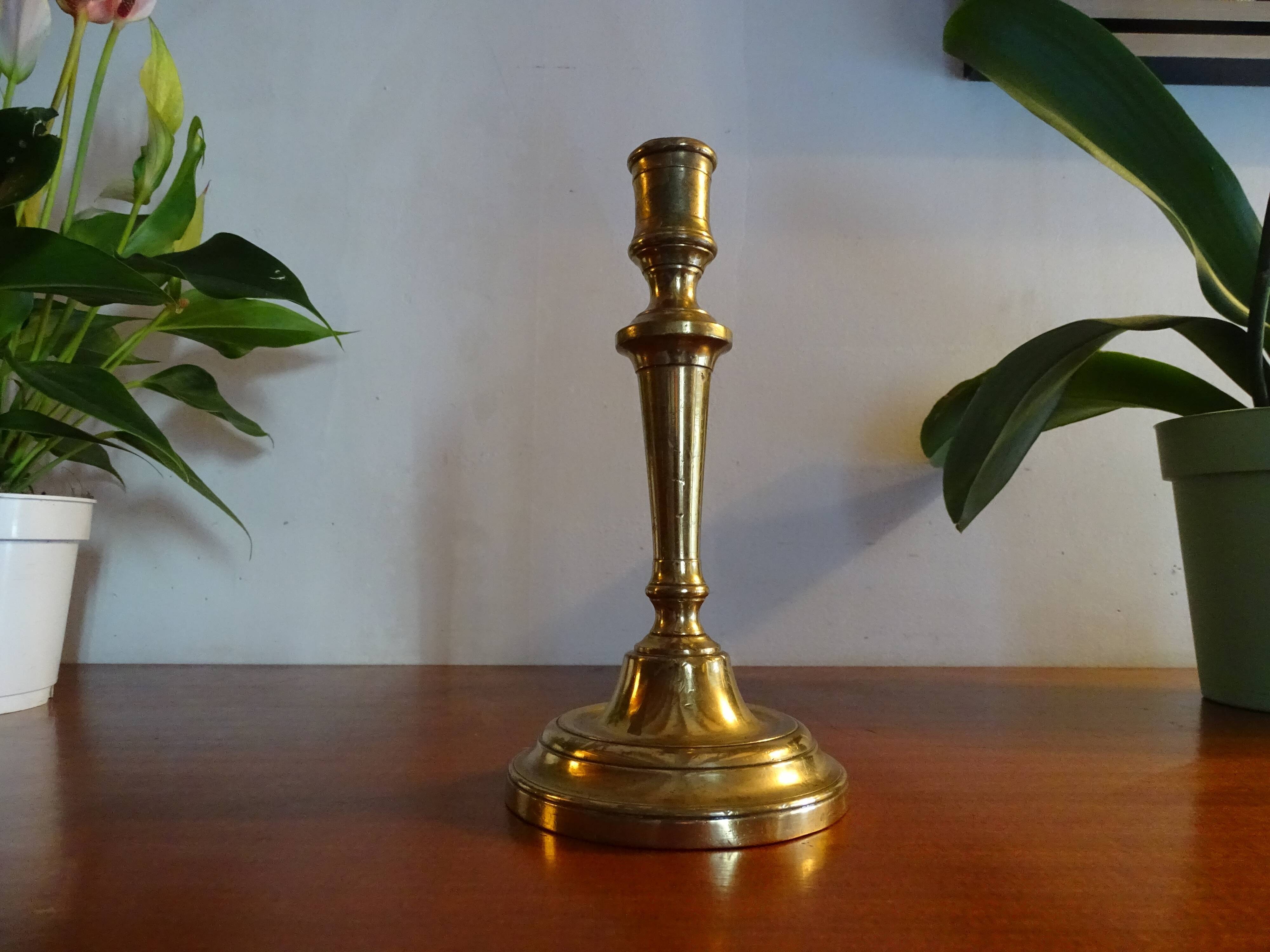 Old brass candle holder and its candle 21.5 cm
