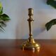 Old brass candle holder and its candle 21.5 cm
