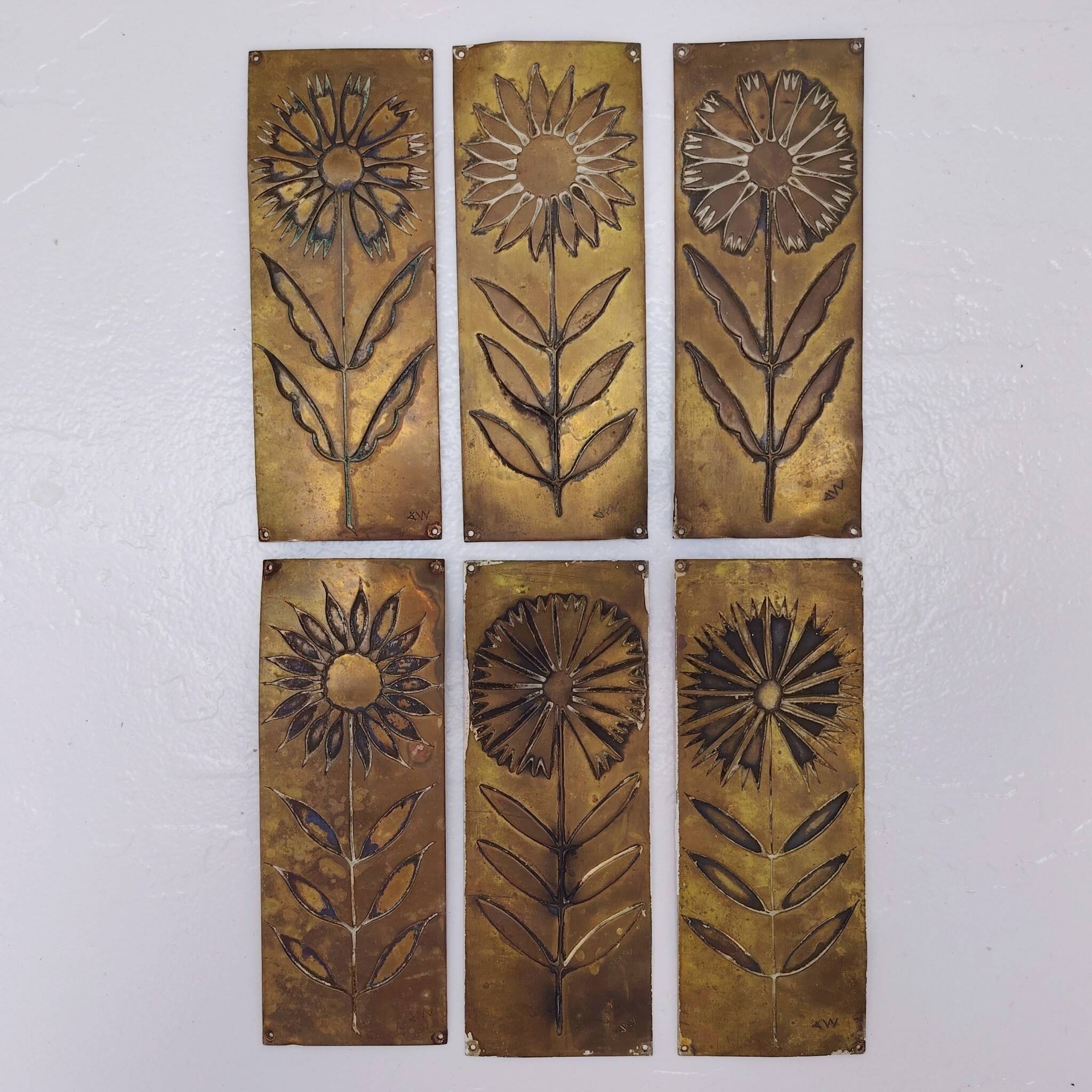 Six cleanliness plaques, flower design, brass.
