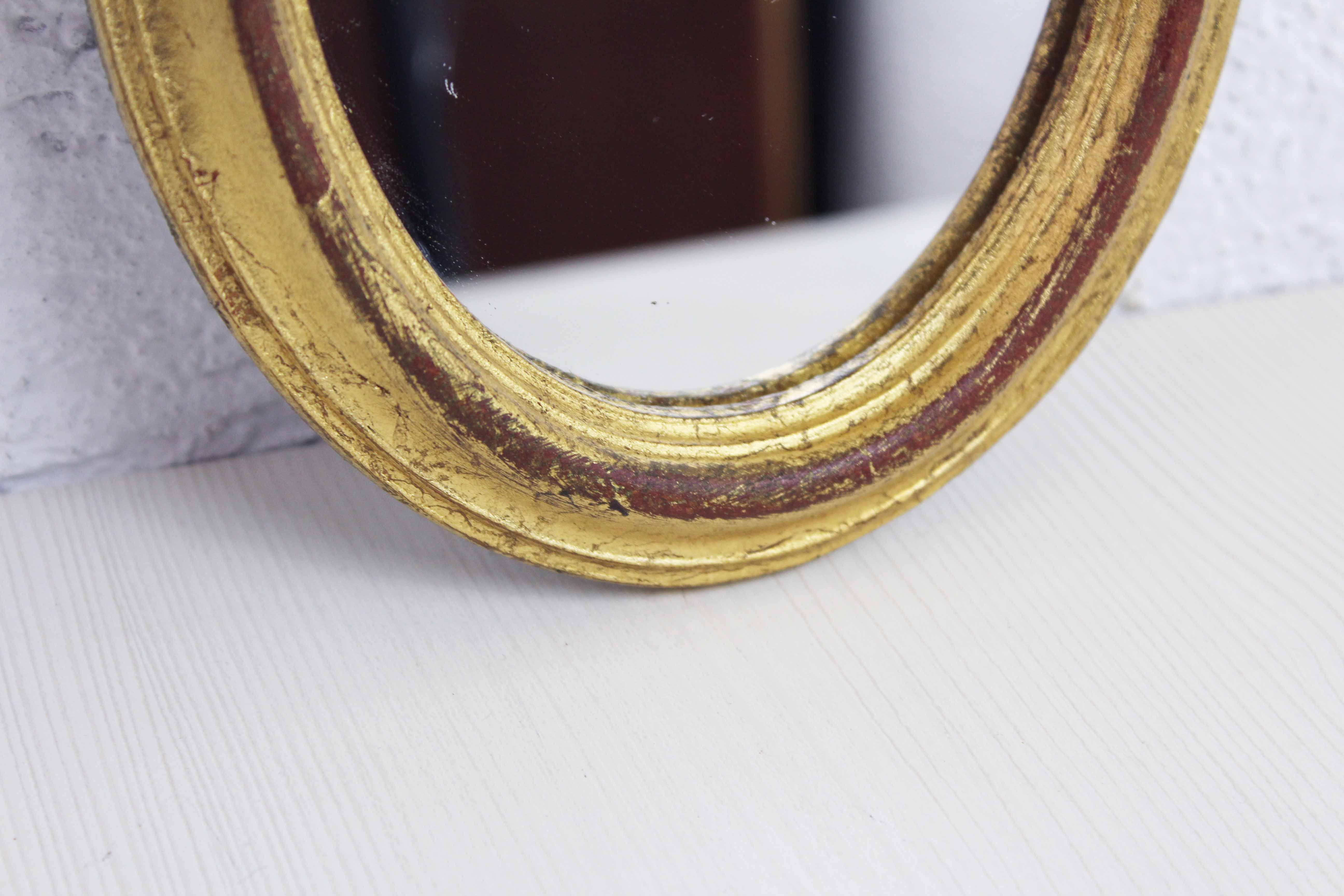 Golden oval mirror