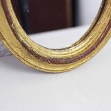 Golden oval mirror