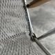 Pair of vintage silver aluminum wire folding chairs with wooden armrests — industrial minimalist