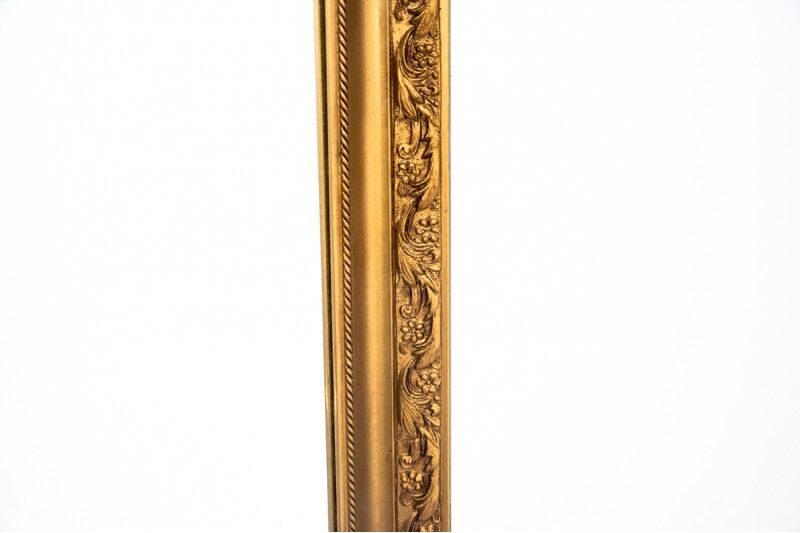 A mirror in a golden frame