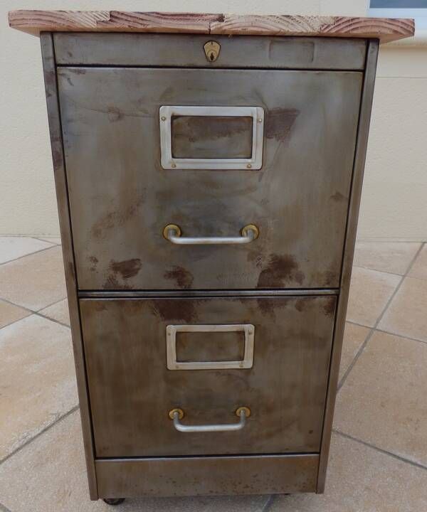 Vintage industrial metal furniture with a rusty effect, featuring two drawers on wheels.