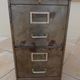 Vintage industrial metal furniture with a rusty effect, featuring two drawers on wheels.