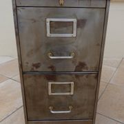Vintage industrial metal furniture with a rusty effect, featuring two drawers on wheels.