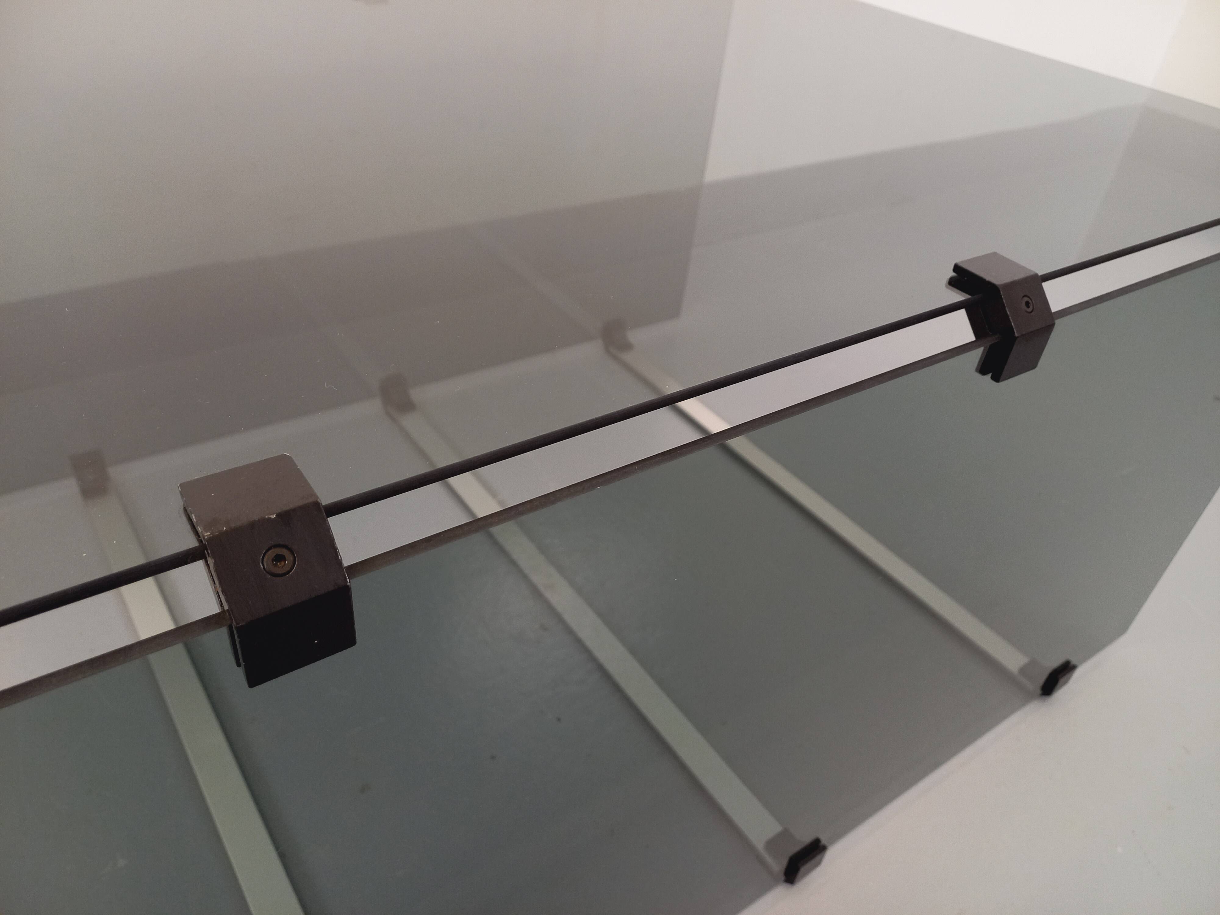 Vintage coffee table in smoked glass, black metal and cast aluminum