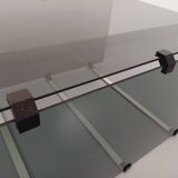 Vintage coffee table in smoked glass, black metal and cast aluminum