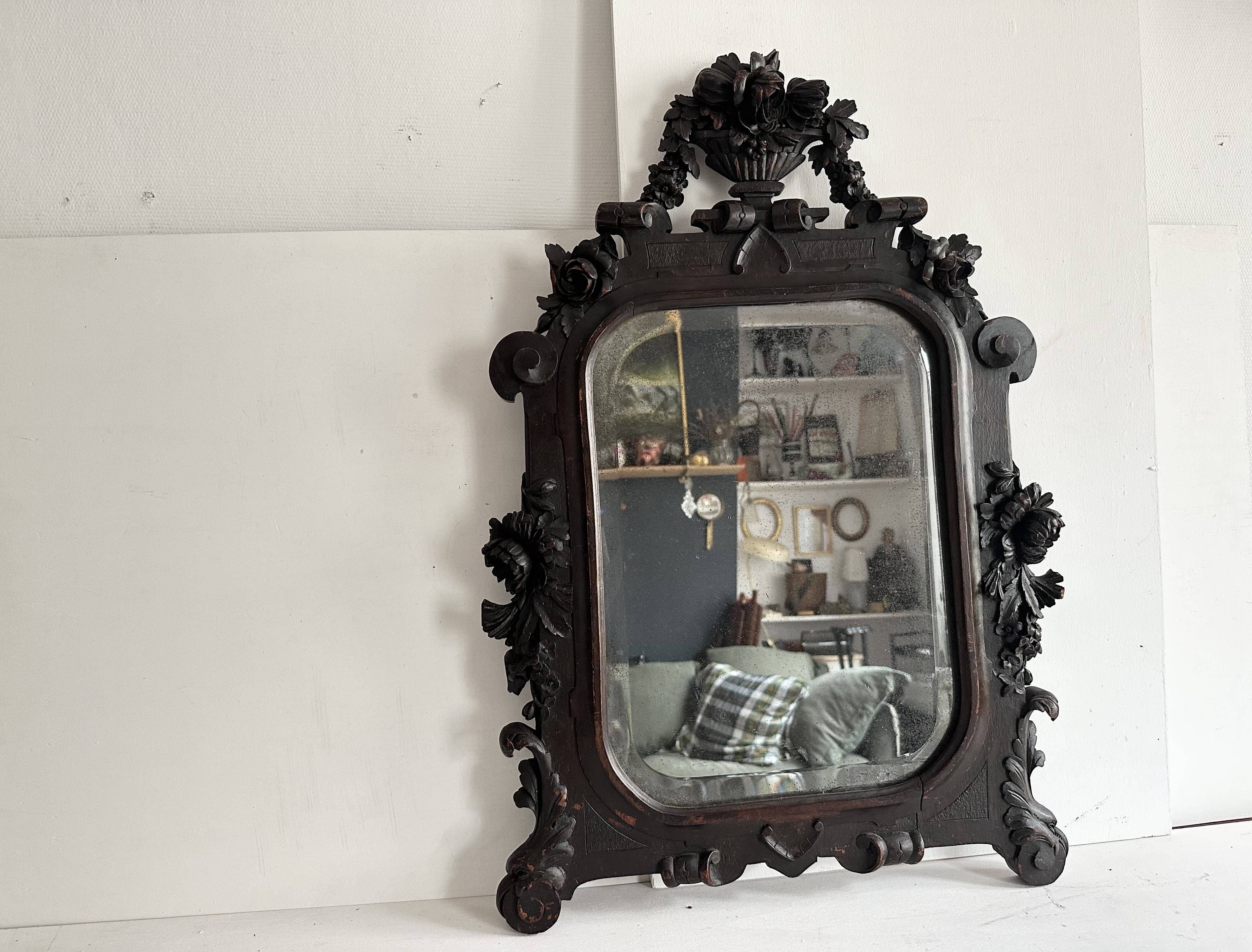 Napoleon III mirror in carved blackened wood, 19th century