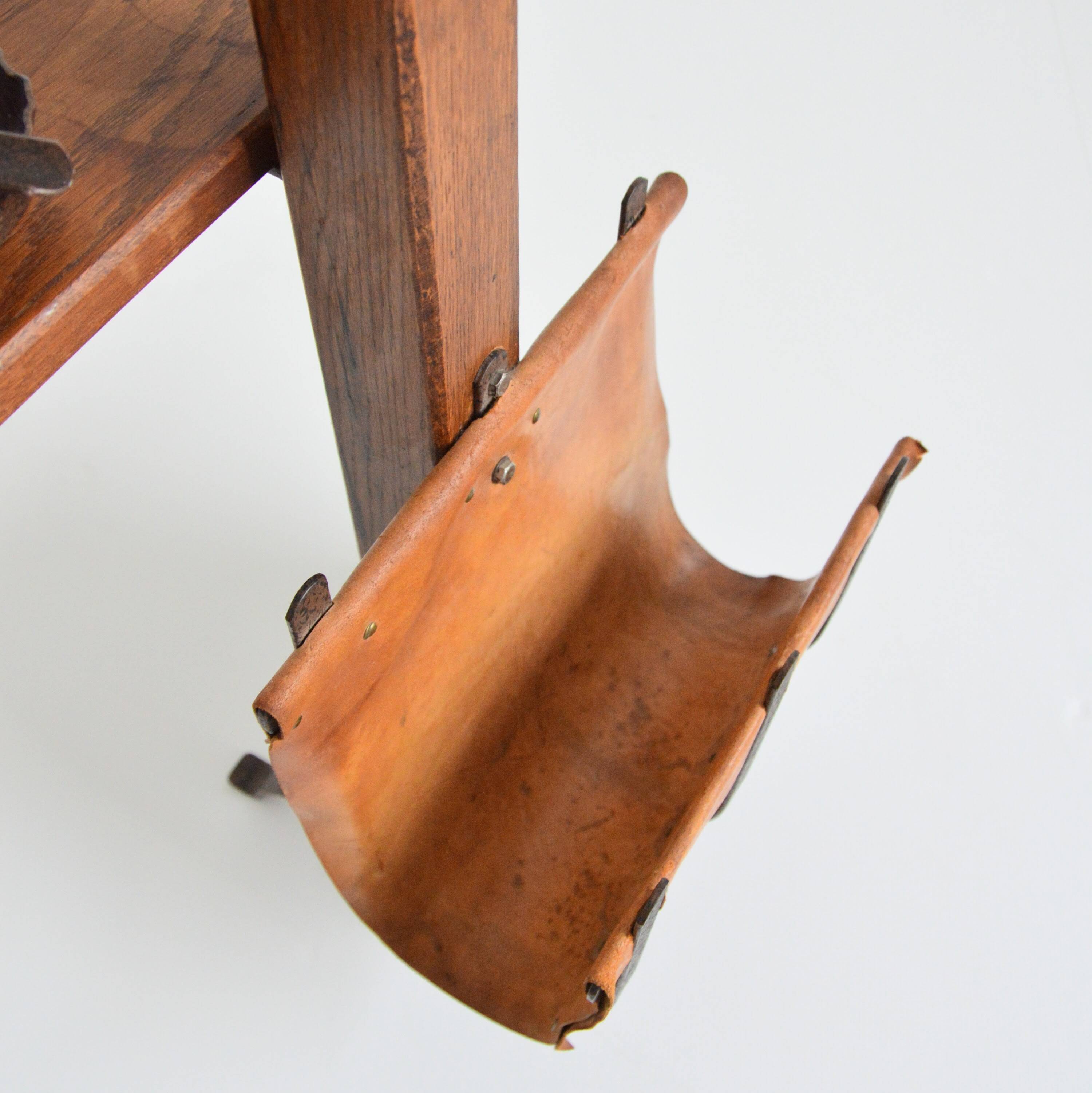 Vintage leather magazine rack with shelf and brutalist/rustic ashtray.
