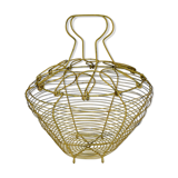Old egg basket in yellow metal wire