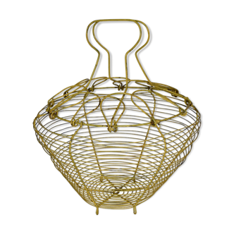 Old egg basket in yellow metal wire