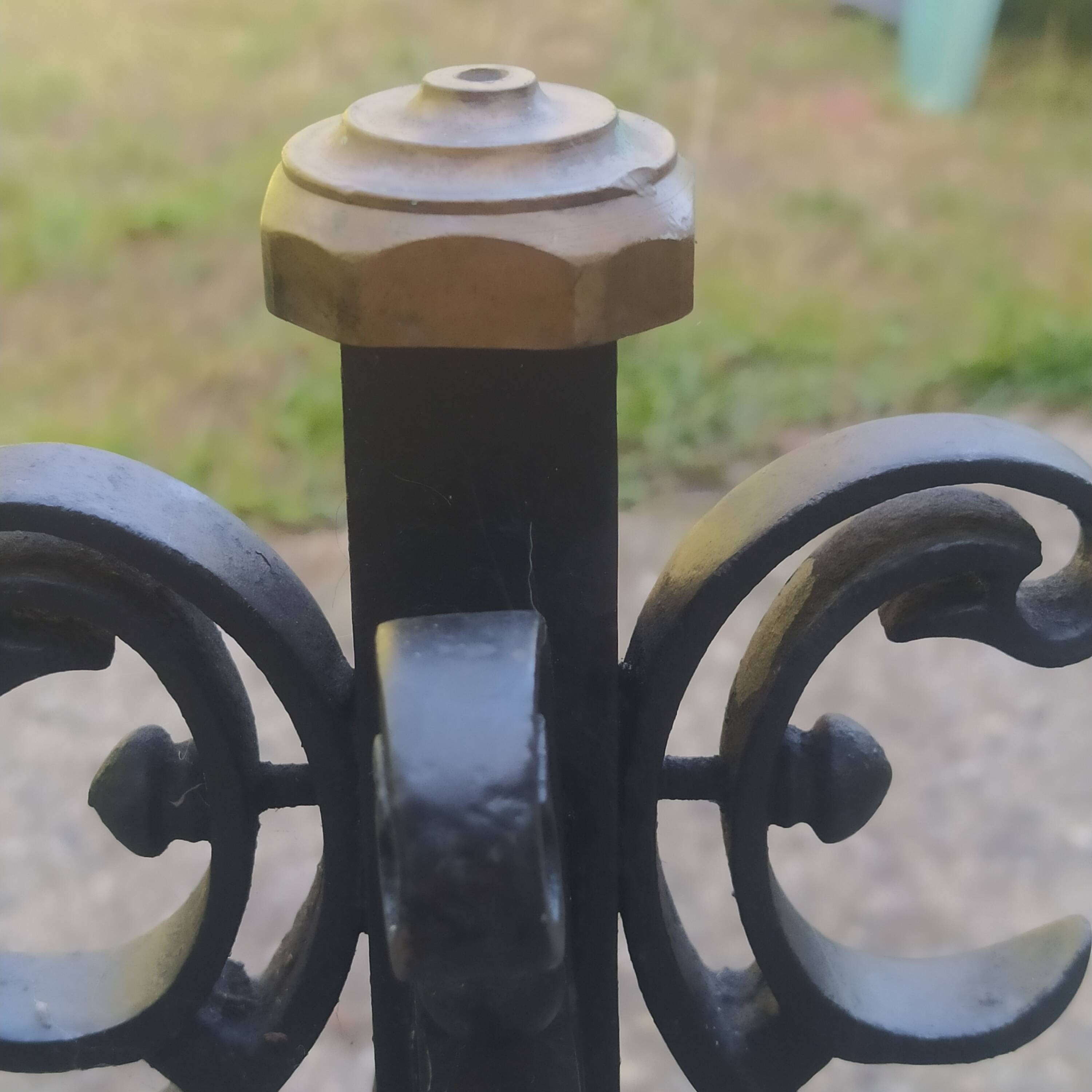 pair of large 20th century metal andirons with mascaron decoration