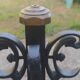 pair of large 20th century metal andirons with mascaron decoration