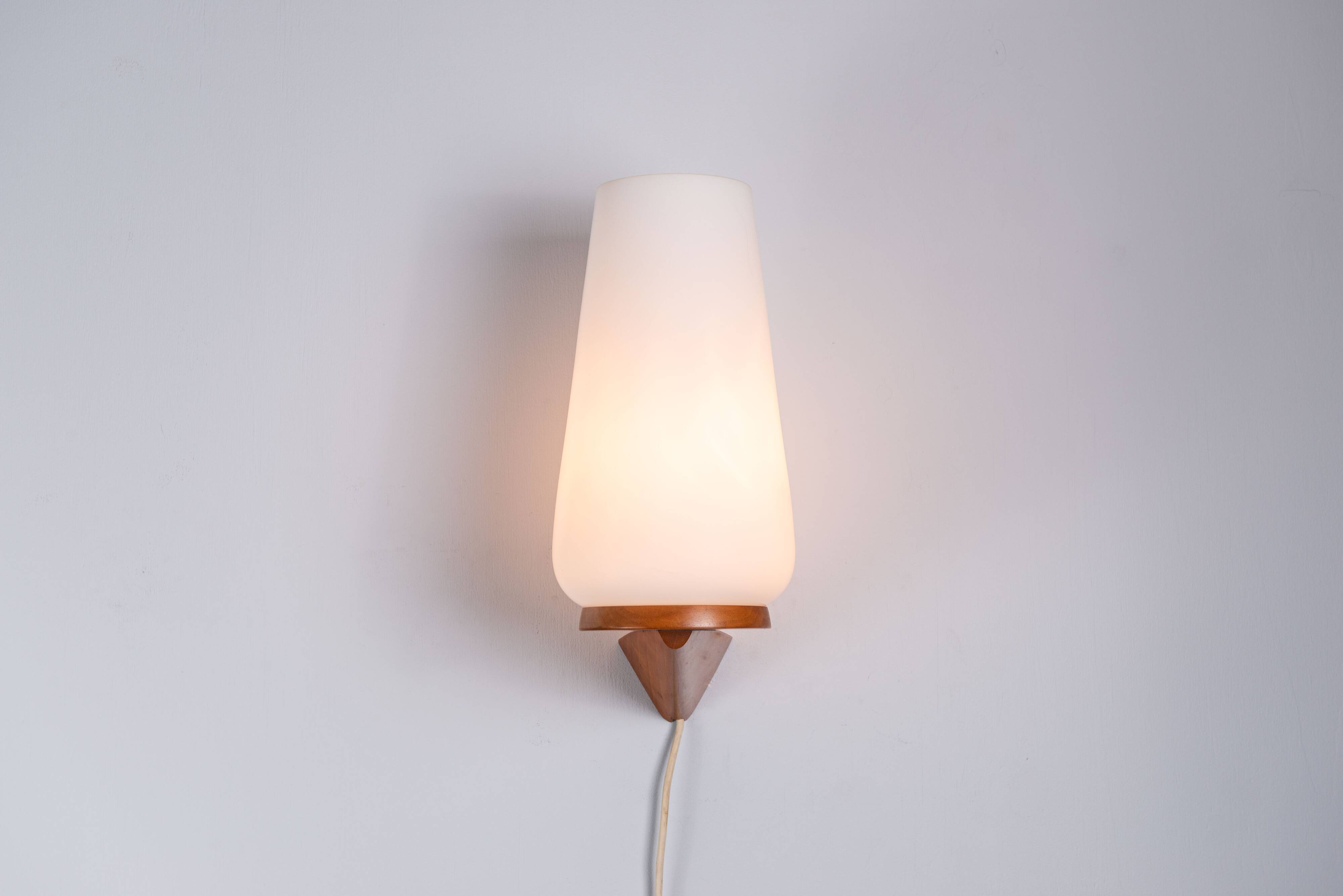 Wall lamp with opal glass shade on wooden base by Philips