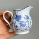 White porcelain milk jug with blue floral designs.