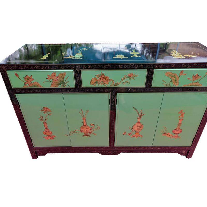 Lacquered buffet in soft green with floral patterns.