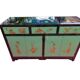 Lacquered buffet in soft green with floral patterns.