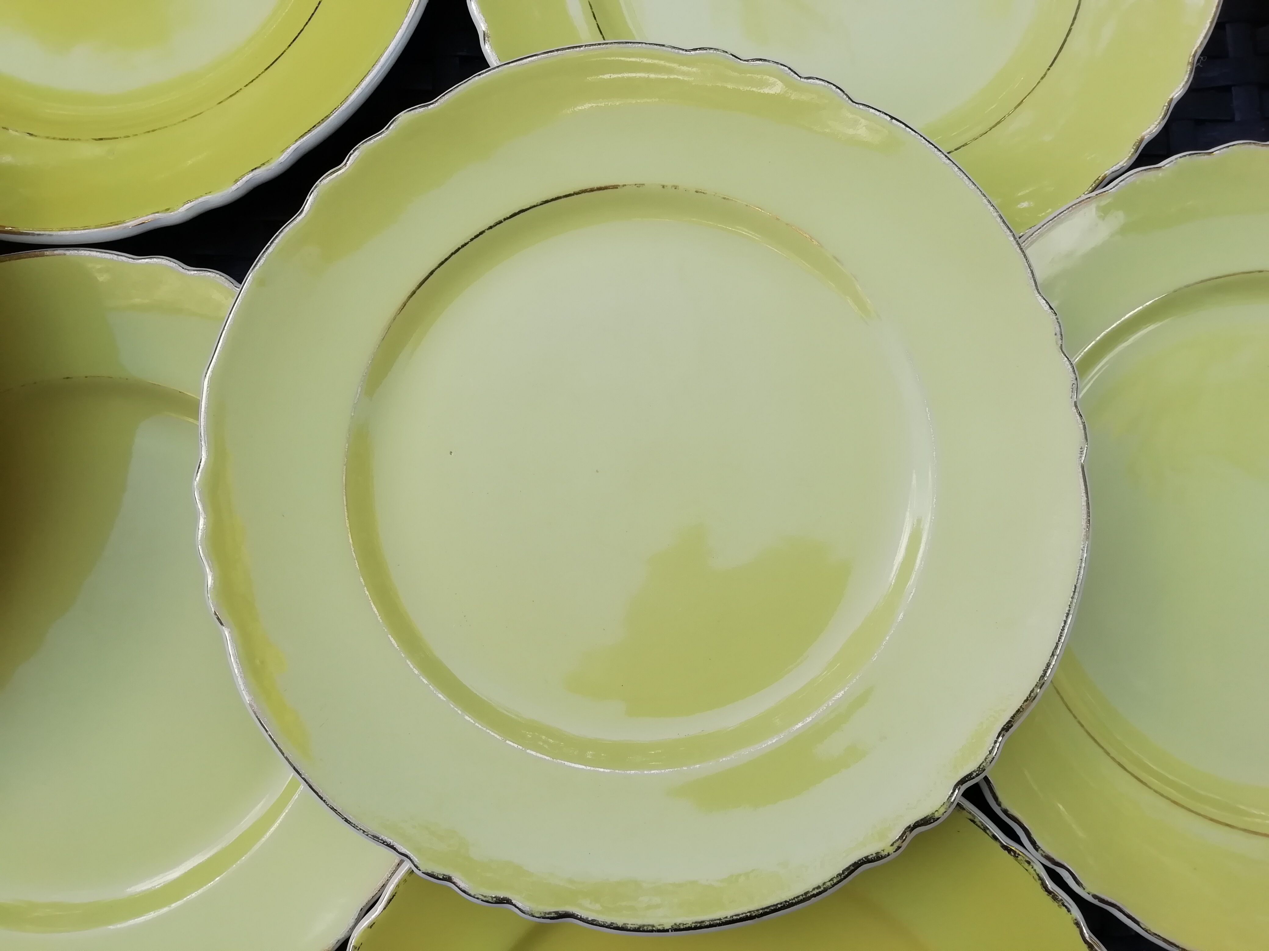 11 yellow earthenware plates from North Orchies