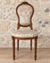 Antique Louis XVI style chair in wood and floral fabric.