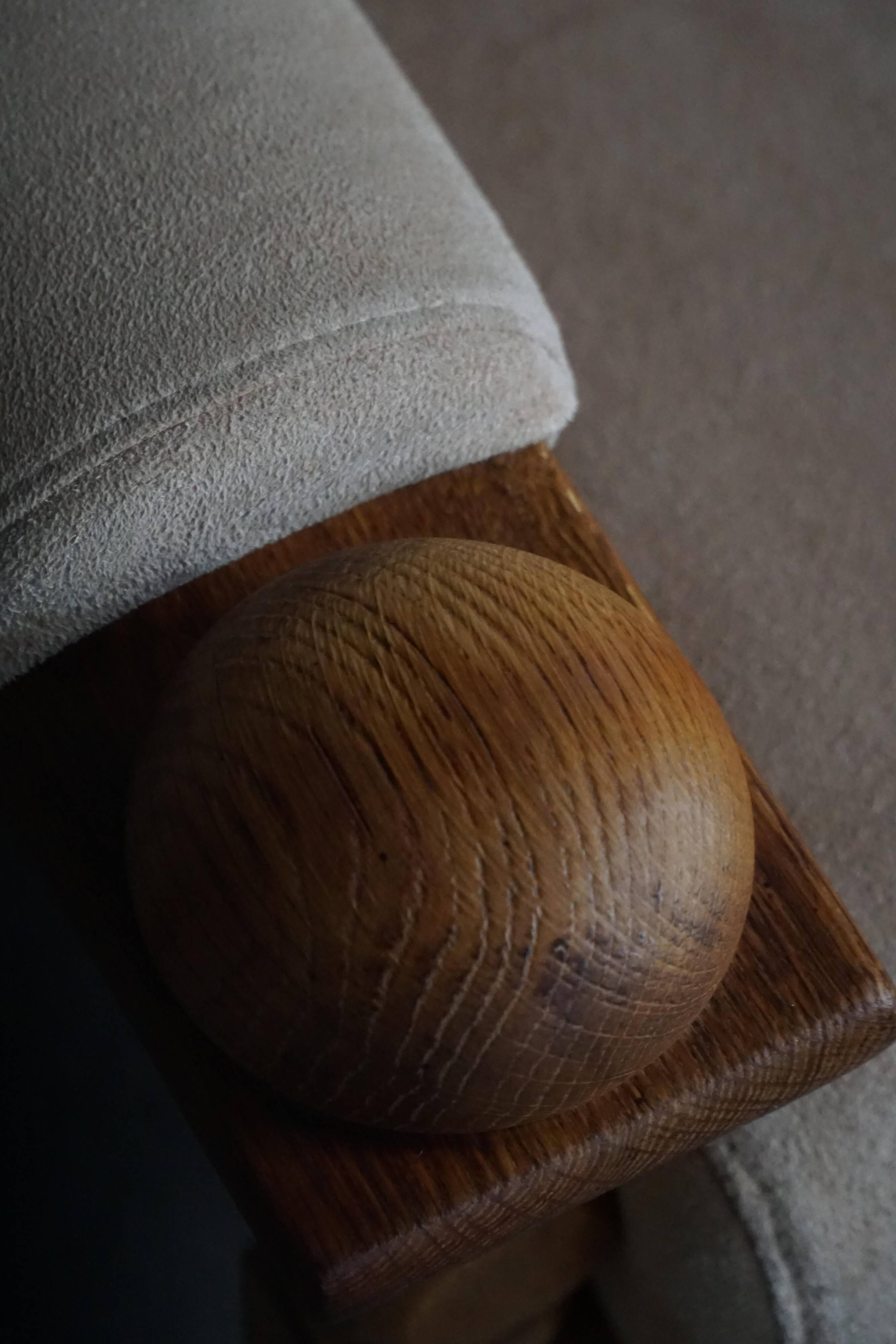 Mid-20th century, pair of armchairs by Henning Kjærnulf, oak and alcantara, 1960s.