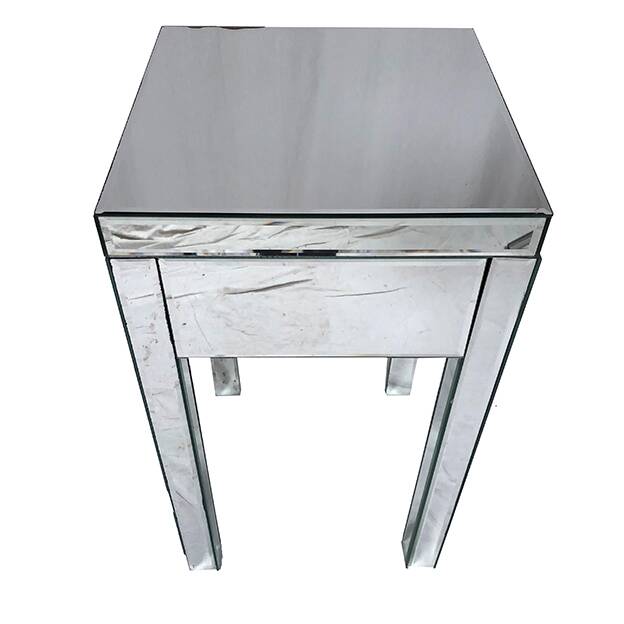 Bedside table covered with beveled mirrors on all sides