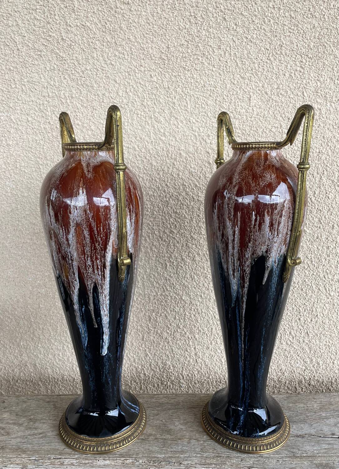 Two large stoneware vases with bronze fittings.
