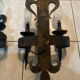 Pair of wrought iron wall lights in fleur-de-lis château style.