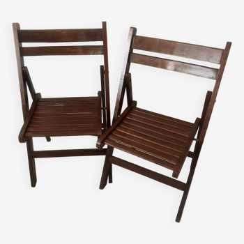 Pair of folding chairs in dark wooden slats