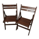 Pair of folding chairs in dark wooden slats