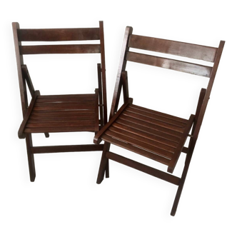 Pair of folding chairs in dark wooden slats