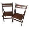 Pair of folding chairs in dark wooden slats