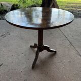 Antique round table with floral details.