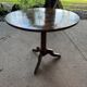 Antique round table with floral details.