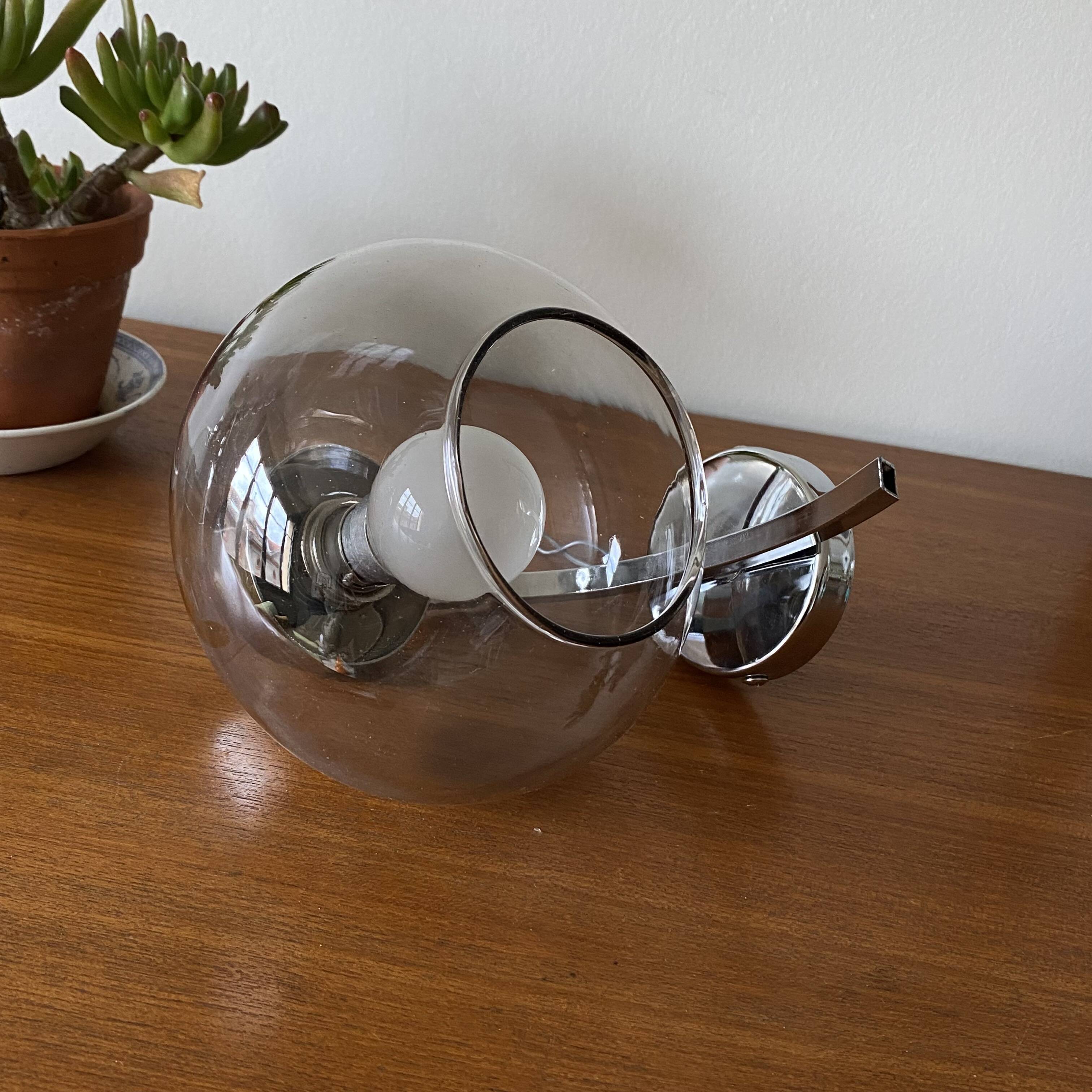 Wall light in chromed metal and smoked grey glass globe