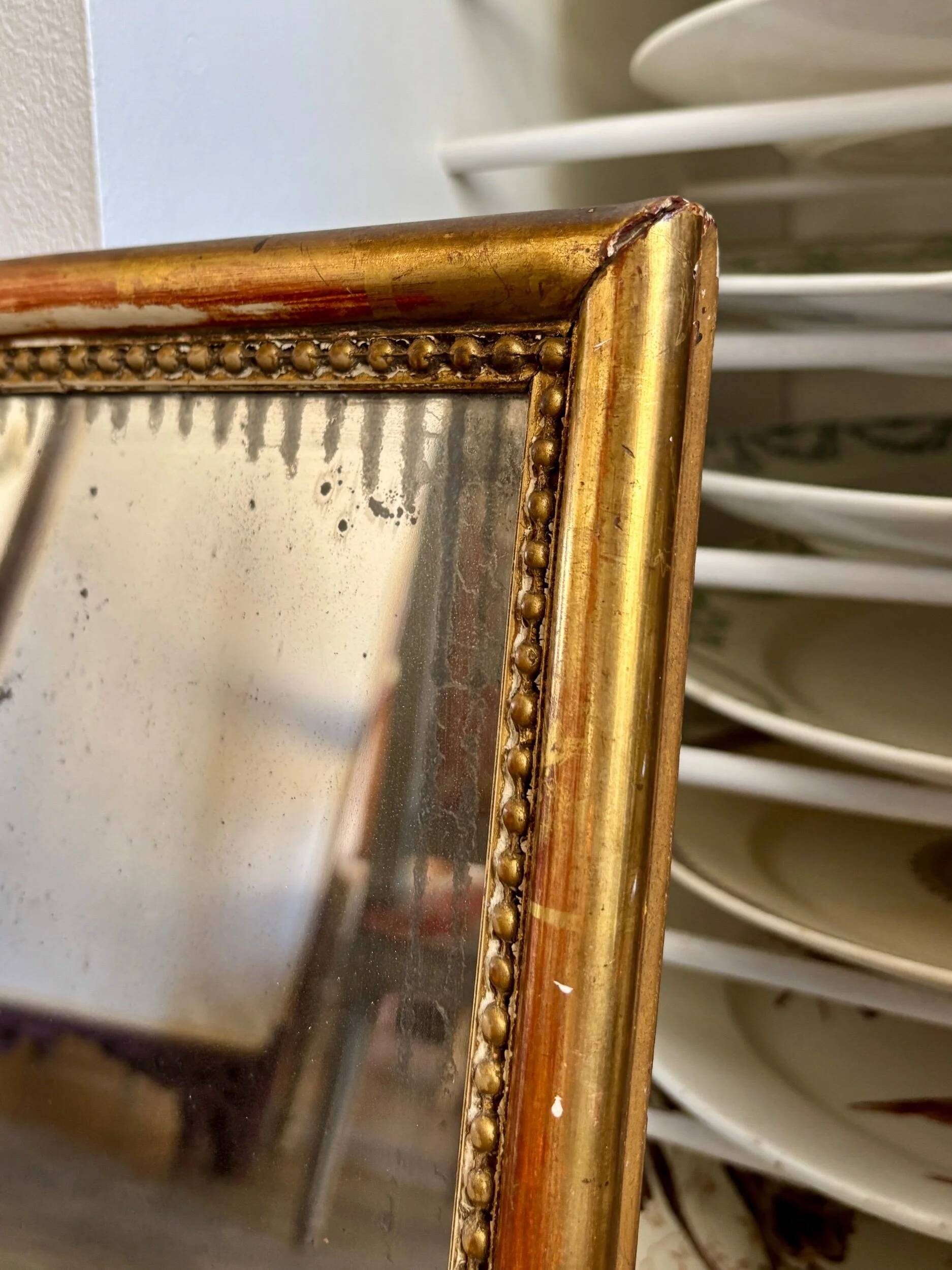 Wooden mirror with gilded stucco and beaded frieze, 45 x 37 cm