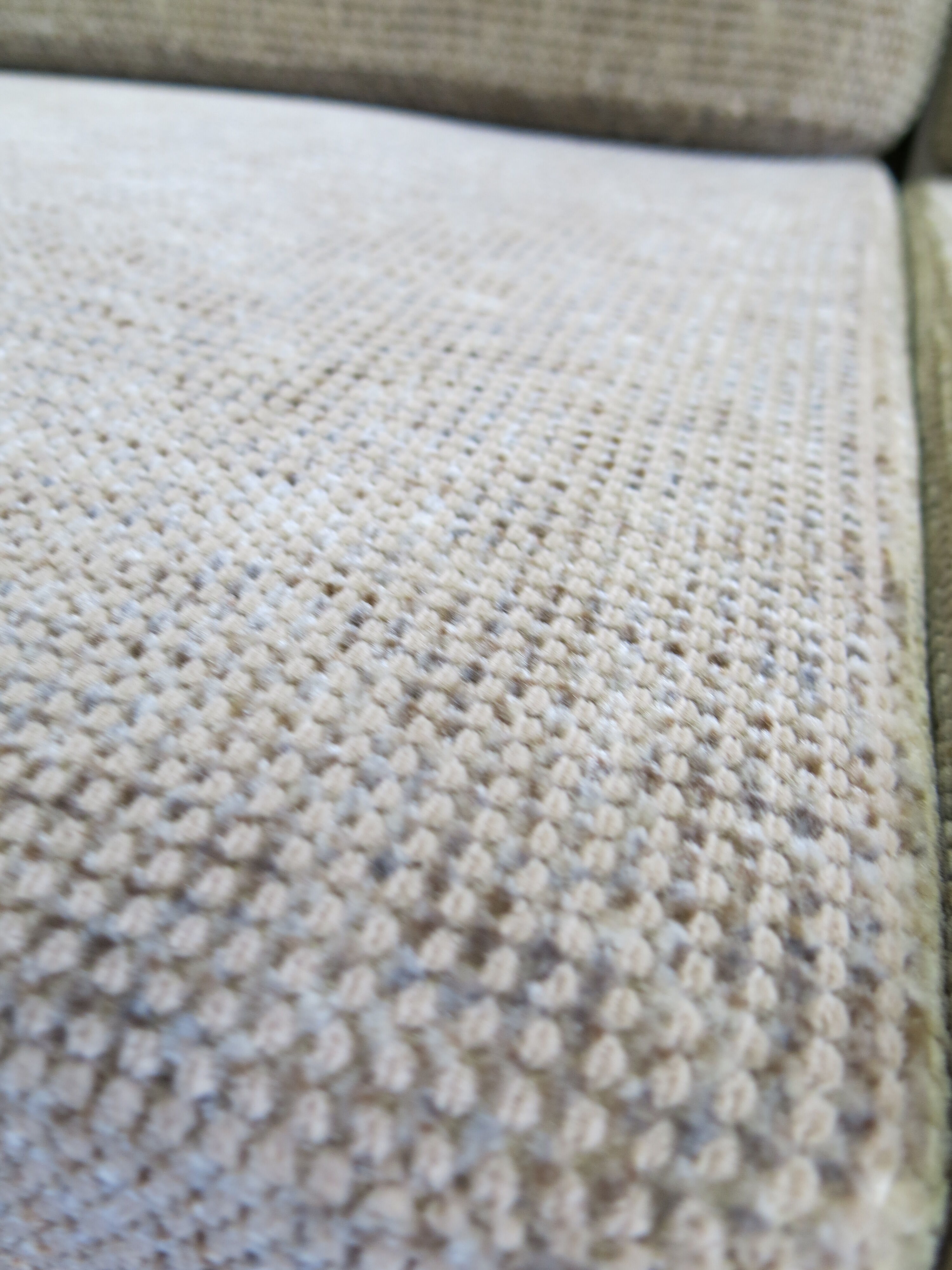 Two-seater rattan sofa with natural tones