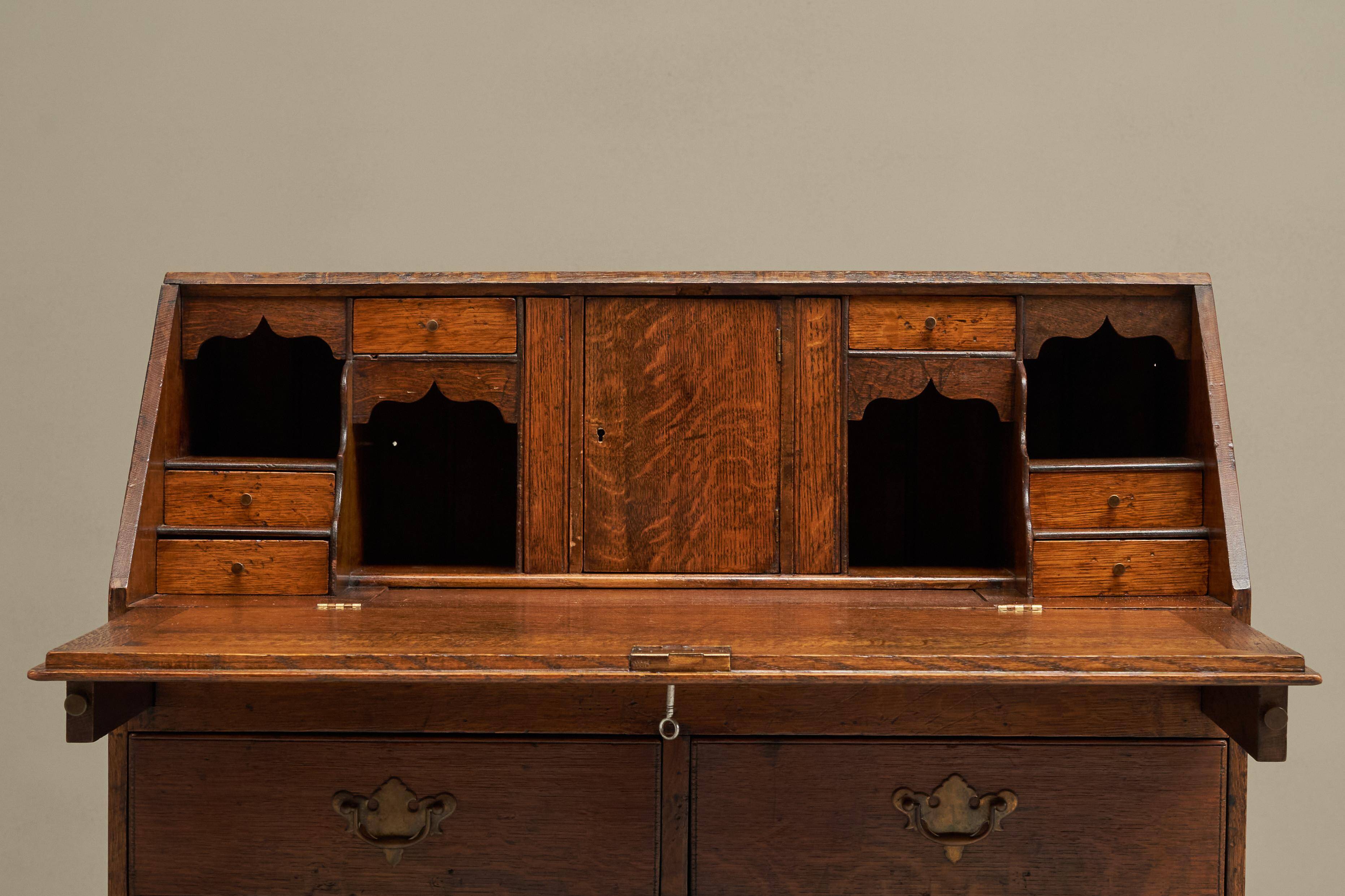 Antique English oak secretary with drop-down front.