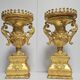 Rare pair of carved and gilded wooden vases, with a refined style inspired by the Empire.