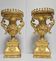Rare pair of carved and gilded wooden vases, with a refined style inspired by the Empire.