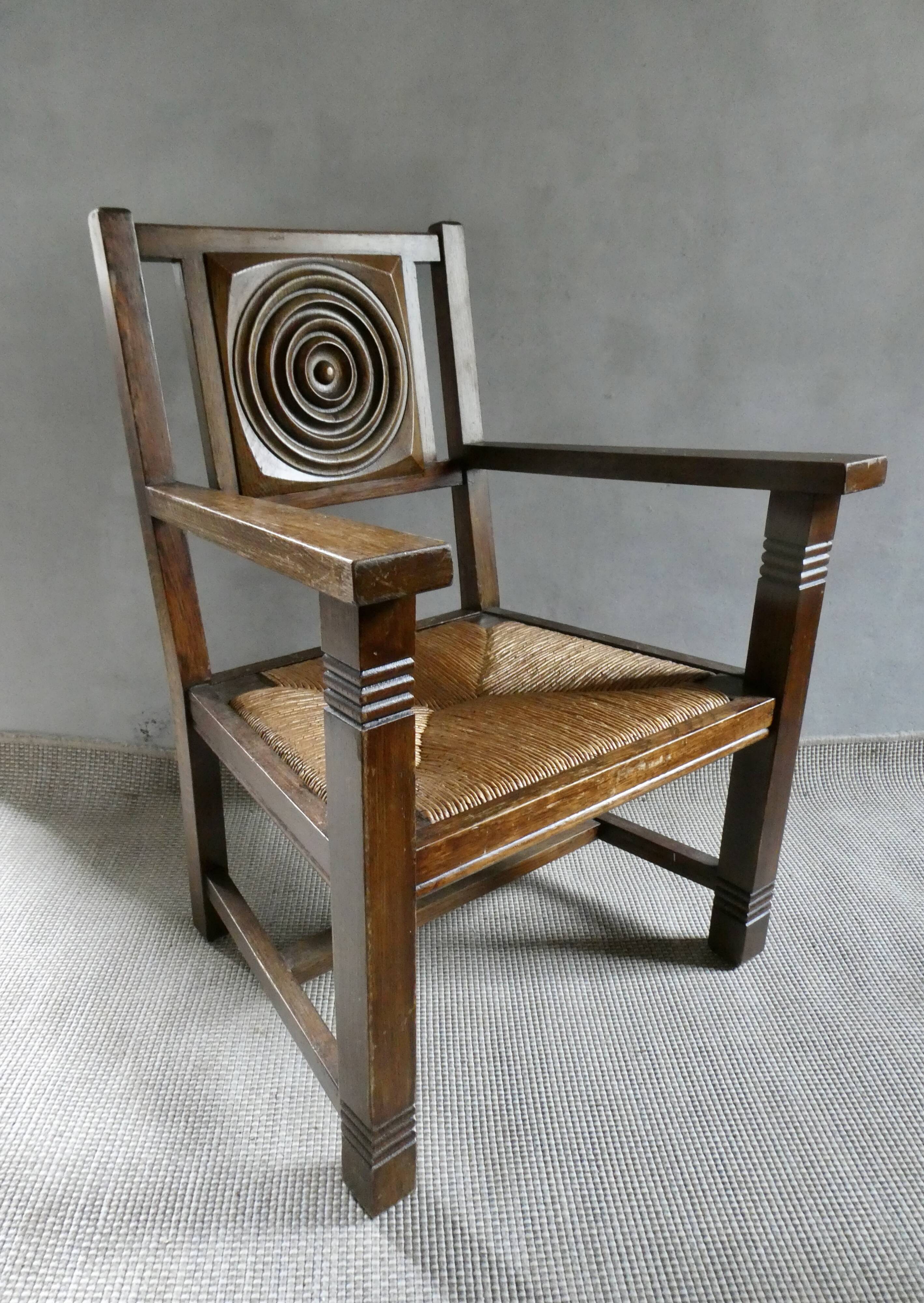 Armchair in carved solid wood with straw seat