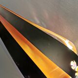 Hanging lamp in thin metal pieces, copper colored and black with prisms.