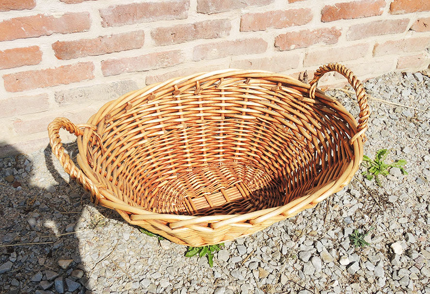 Old oval wicker linen basket, light rattan